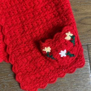 Red crocheted cardigan with flower design